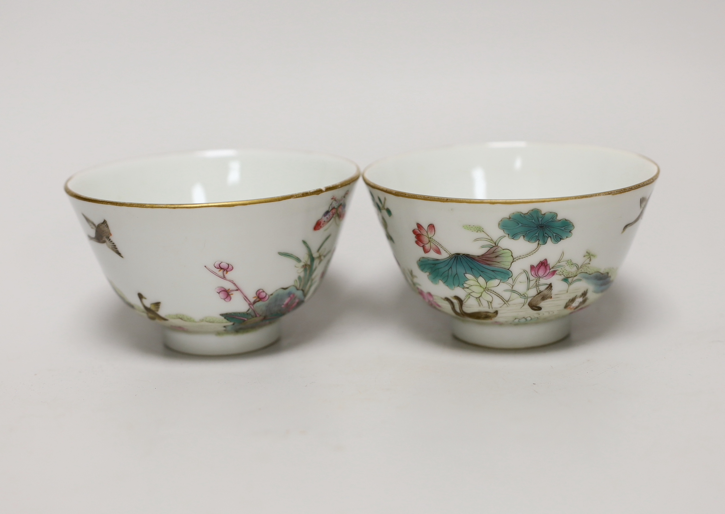 A pair of Chinese famille rose bowls hand painted with birds amongst flowers, each 10cm in diameter